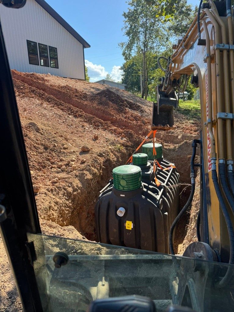 Excavator setting a new septic tank in Southwest Missouri