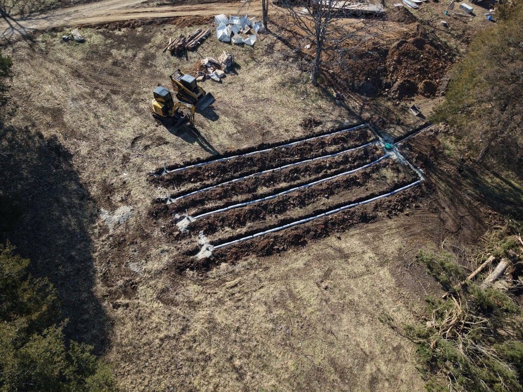 Aerial view of cleared acreage with equipment on site